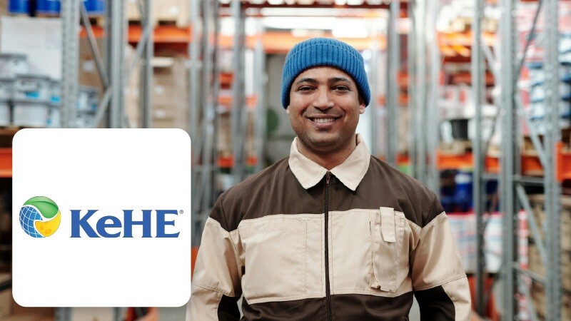 Smiling warehouse worker in beanie with KeHE logo