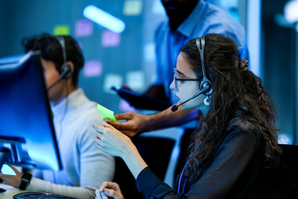 Call center agent with headset at a computer workstation